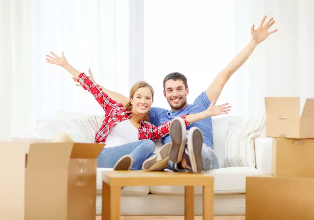 Smiling couple relaxing on sofa